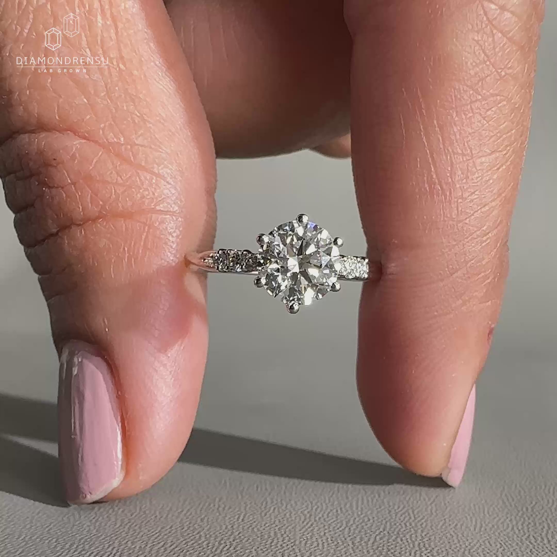 Round cut diamond ring featuring a twisted pave design.
