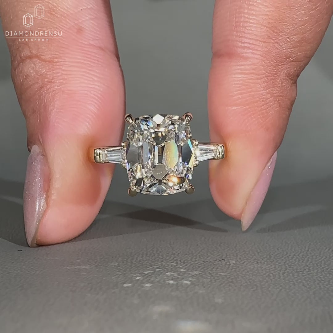 Cushion diamond ring in a three stone design.
