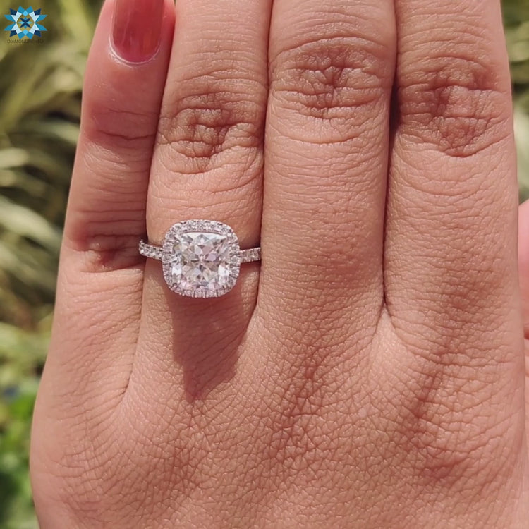 Cushion Rensu halo engagement ring in a cathedral mount.
