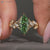 Green centre diamond ring with marquise side stone.