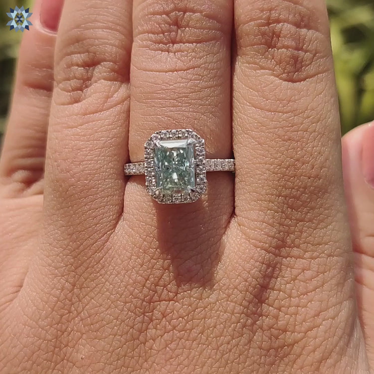 Radiant cut ring designed with 4 claw prongs and a halo setting.
