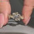 Nature inspired round cut diamond ring with half bezel setting.