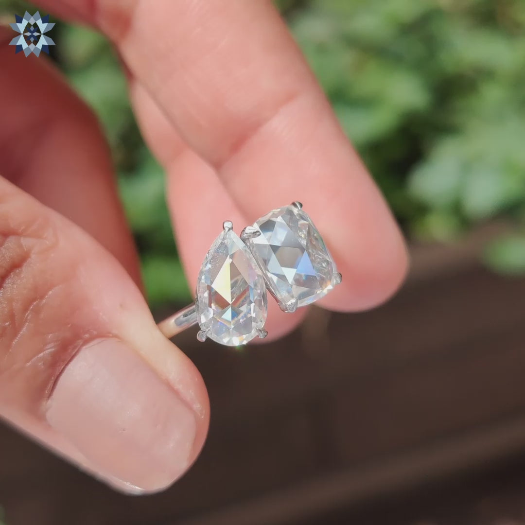White gold ring with pear and cushion rose cut moissanite.

