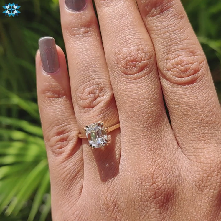 Custom moissanite engagement ring with cushion cut center.
