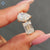 Pear and emerald cut ring in yellow gold with claw prong setting.
