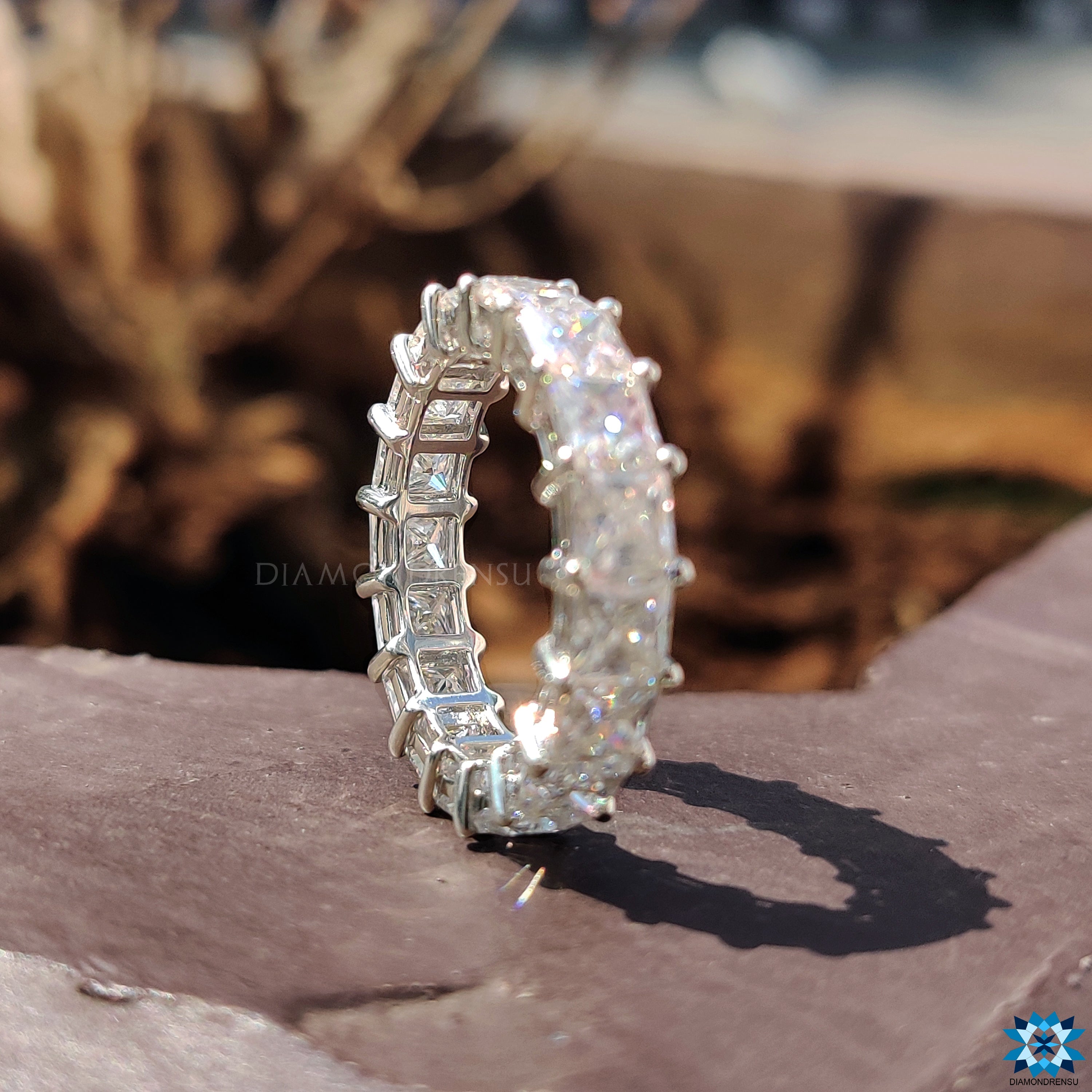 Basket setting ring, designed to enhance the brilliance of the princess cut stones.