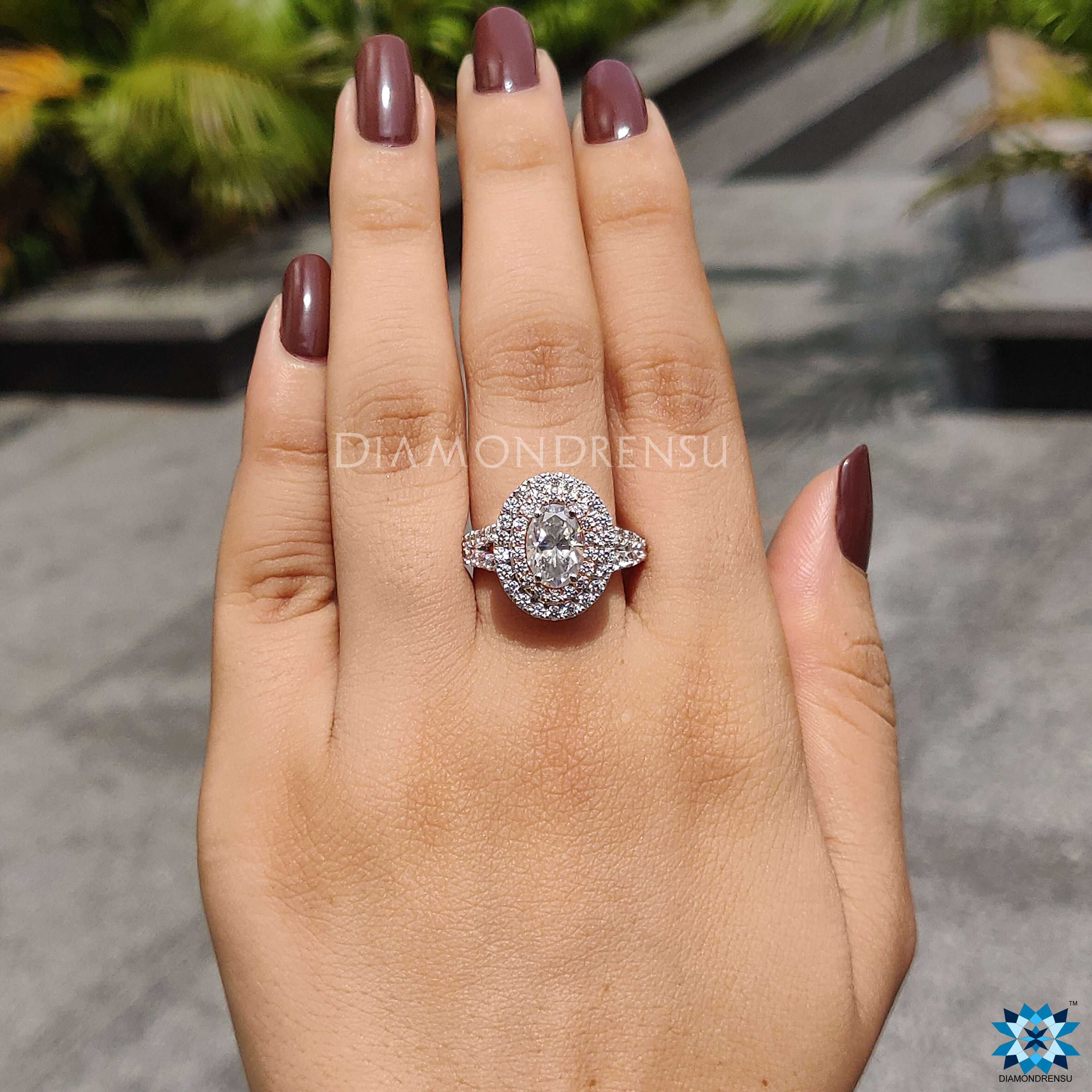 Prong setting ring with an oval moissanite stone in a stunning double halo ring.