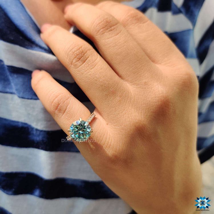 Round cut moissanite hidden halo pave ring in rose gold.
