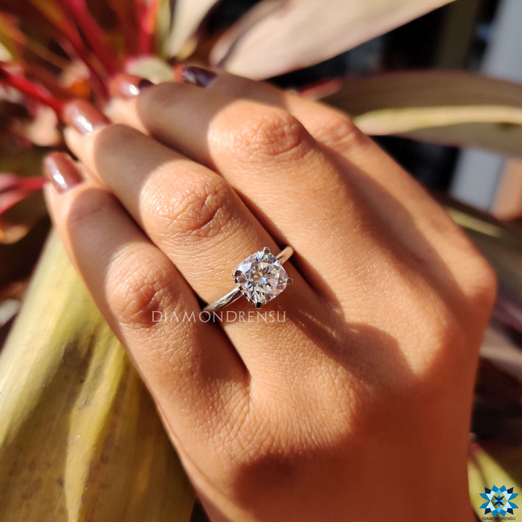 White gold ring with cushion cut moissanite center.
