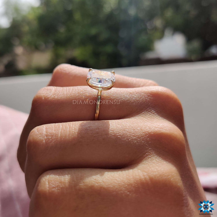 Custom engagement ring featuring an elongated cushion cut moissanite.
