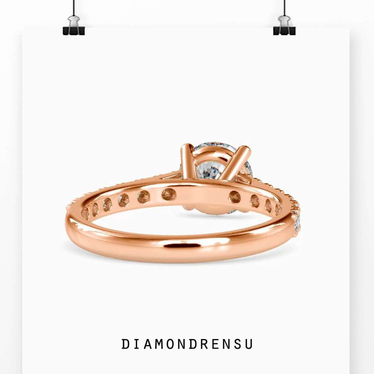 Round diamond engagement ring in custom yellow gold cathedral setting.
