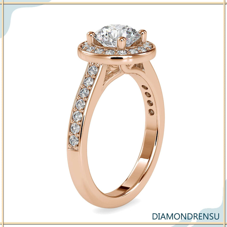 Rose gold engagement ring with round cut halo and four prong setting.
