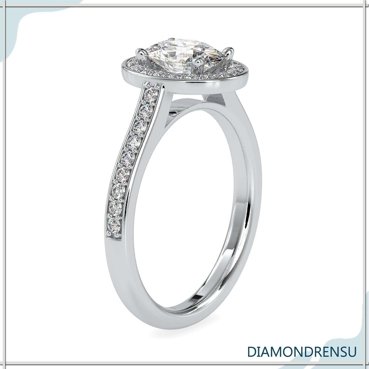 Handmade ring featuring oval diamond in halo setting.
