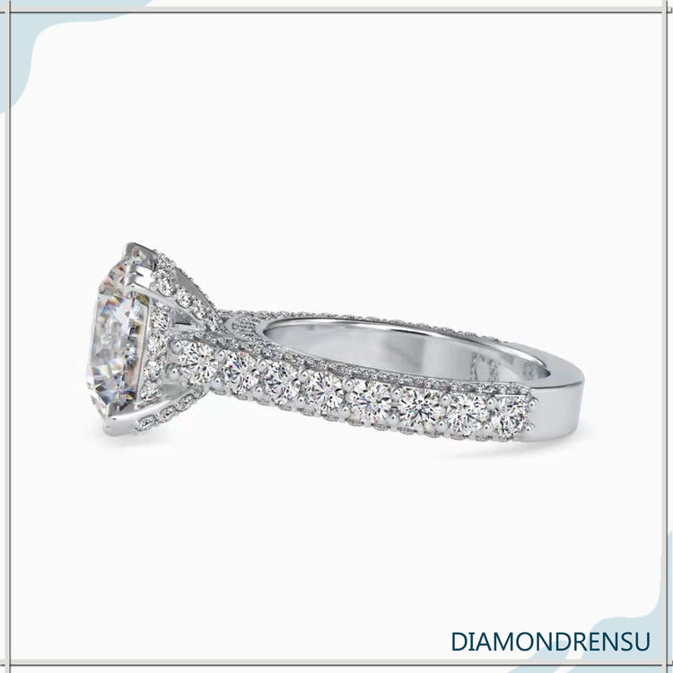 UK engagement ring with bridge accent and cathedral style.
