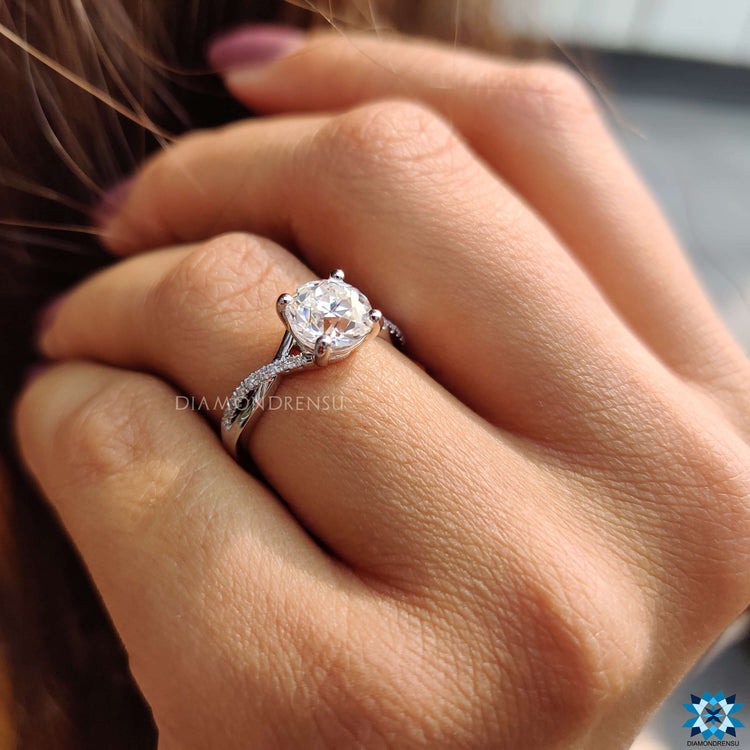 Diamondrensu UK engagement ring with round moissanite center.
