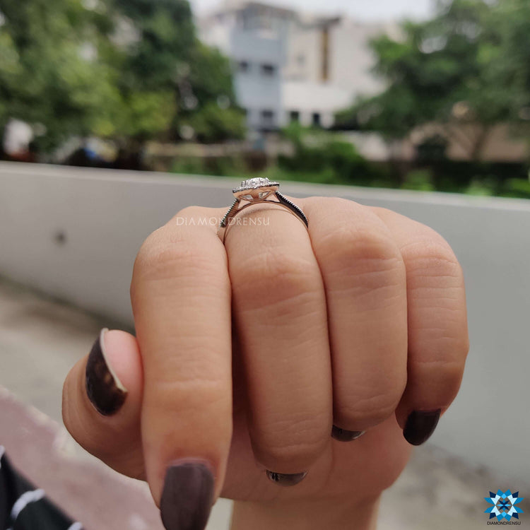Oval cut moissanite ring with marquise halo and white gold band.
