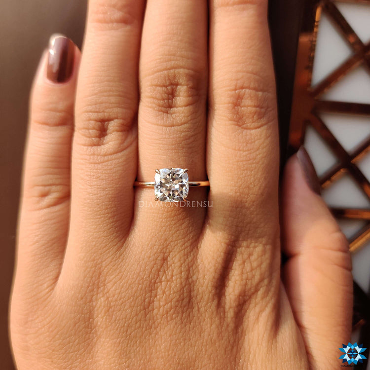 Rose gold ring featuring a handcrafted cushion cut moissanite.

