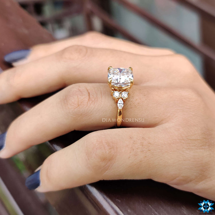 Buy moissanite ring designed with cushion cut centre and marquise side stones.
