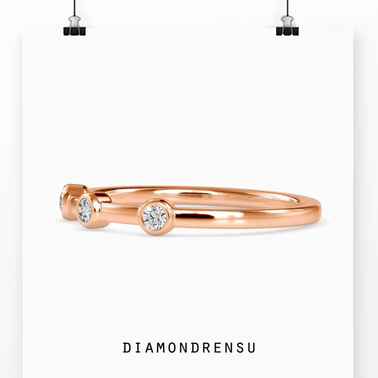 Bezel wedding band with three stone diamond layout.
