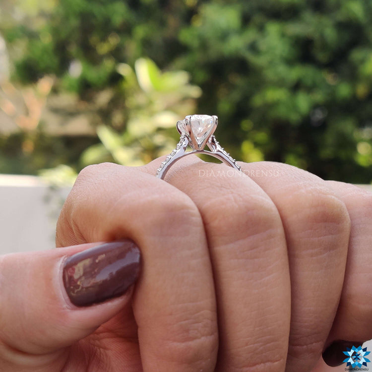 Cushion center engagement ring with moissanite and handcrafted details.
