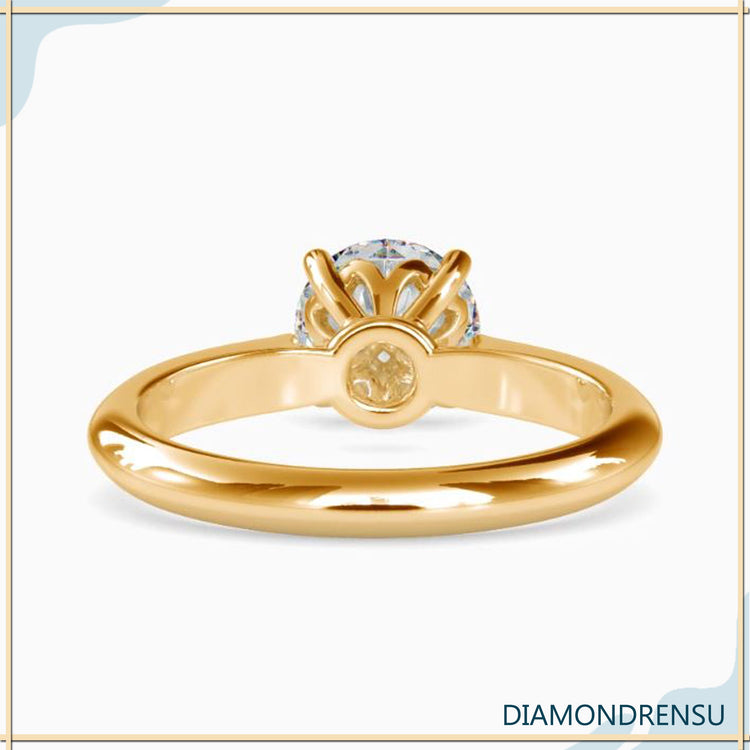 Custom engagement ring with round diamond in knife edge style.
