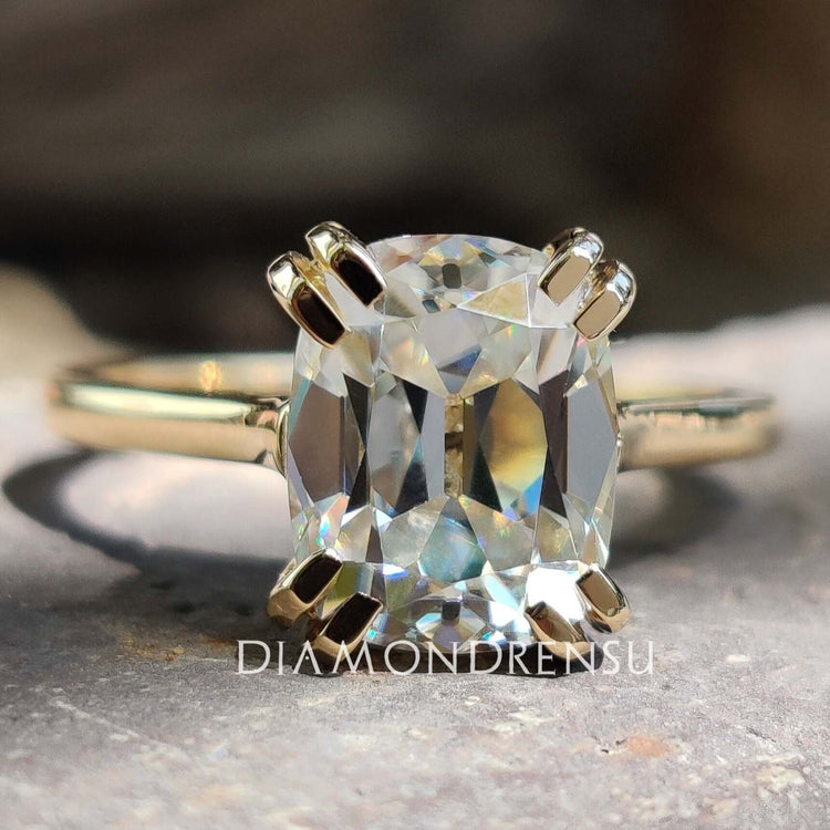 Cushion old European cut moissanite ring in yellow gold.
