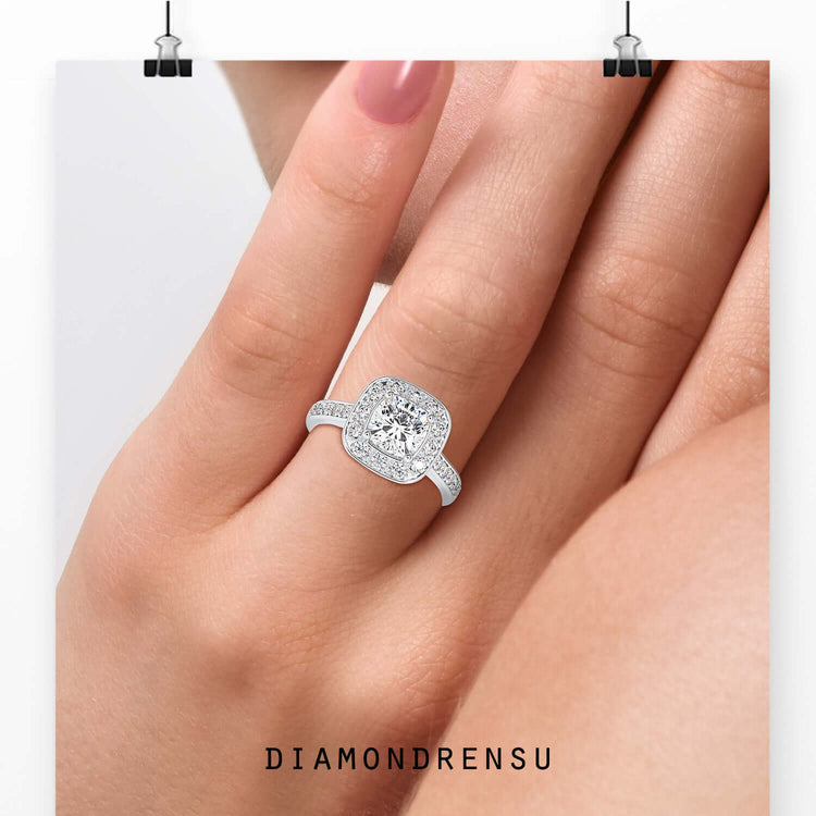 Cushion cut diamond ring with round cut halo and white gold band.
