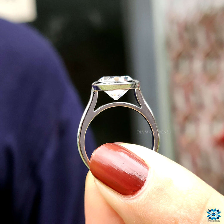 Solitaire engagement ring with moissanite center.
