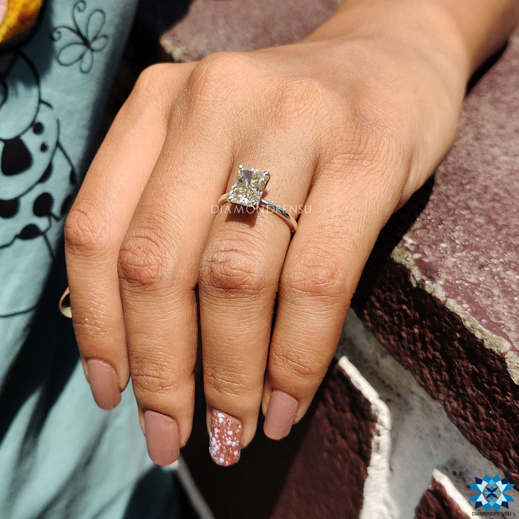Moissanite engagement ring designed with radiant cut and yellow tones in a handmade finish.
