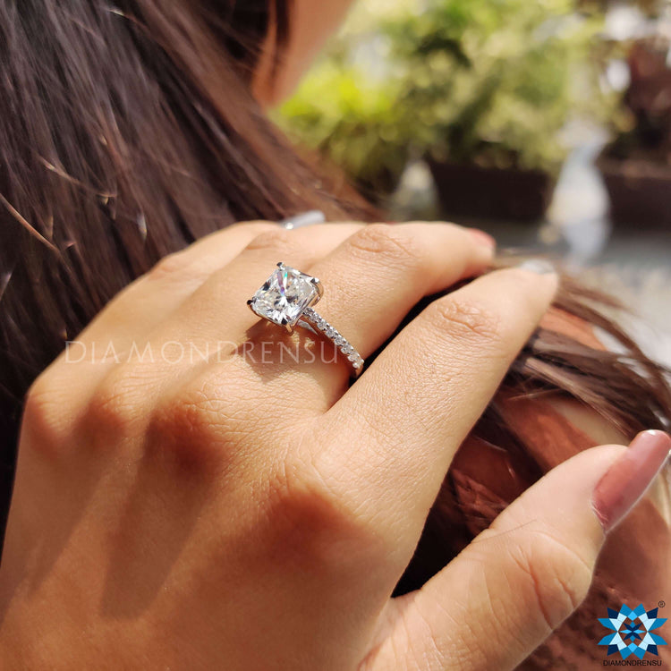 Custom engagement ring featuring radiant moissanite and white gold band.
