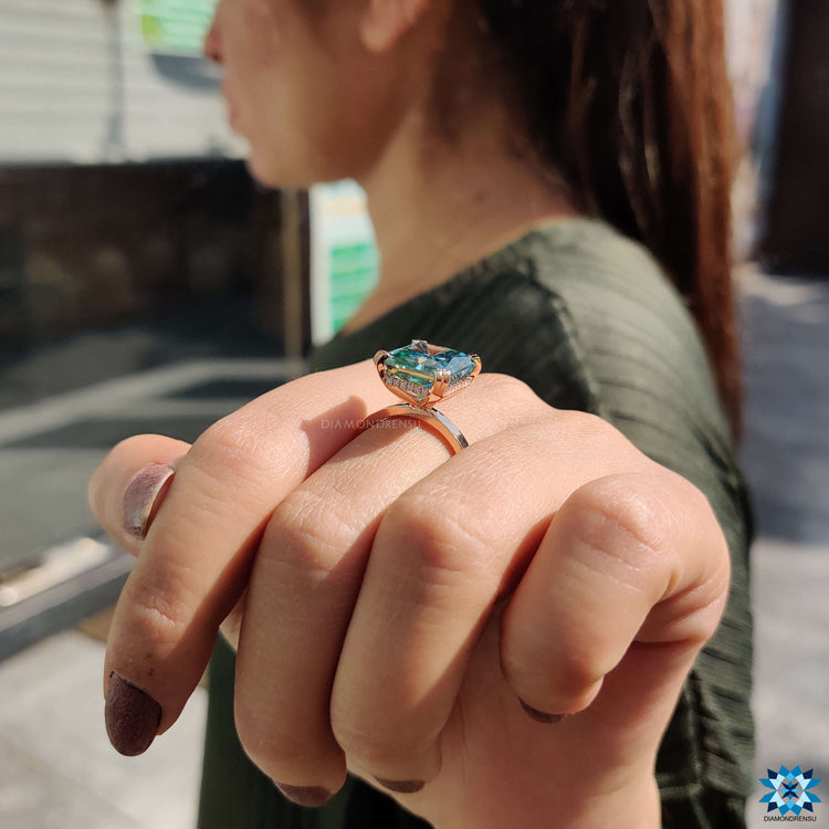 Custom rose gold ring featuring radiant and round stones.
