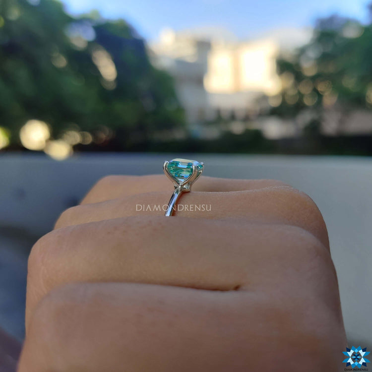 Custom engagement ring with cyan blue moissanite.
