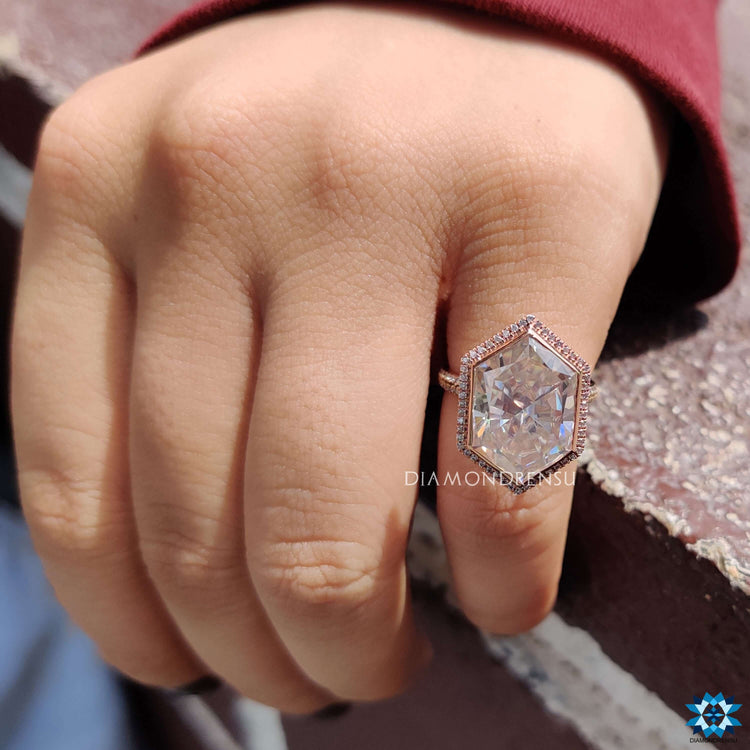 Rose gold ring with bezel set hexagon moissanite center.
