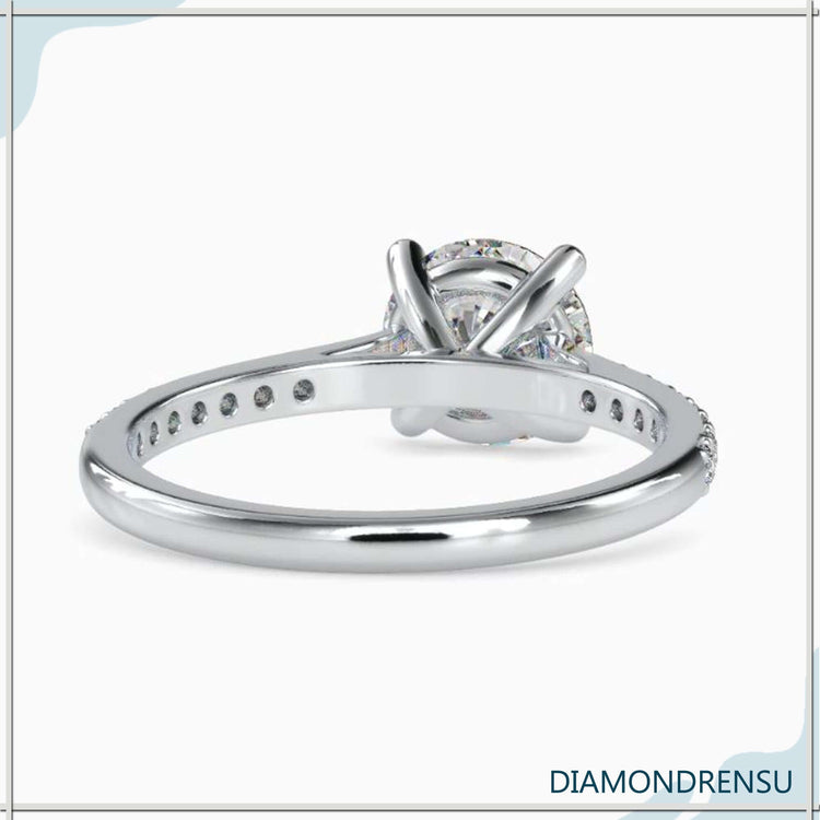 White gold ring with round cut diamond and cathedral setting.
