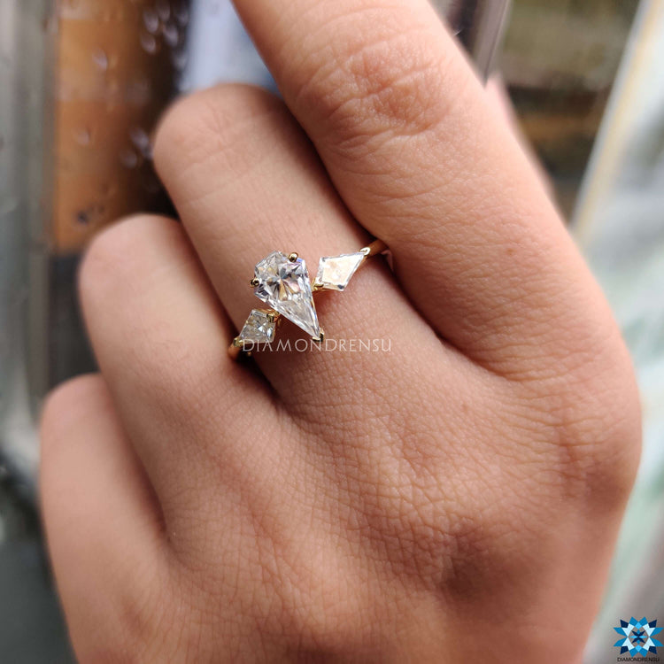 Prong setting ring with spear cut moissanite center.
