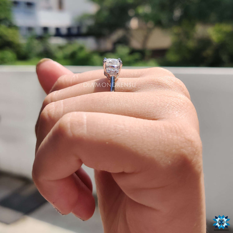 White gold ring featuring three moissanite stones.
