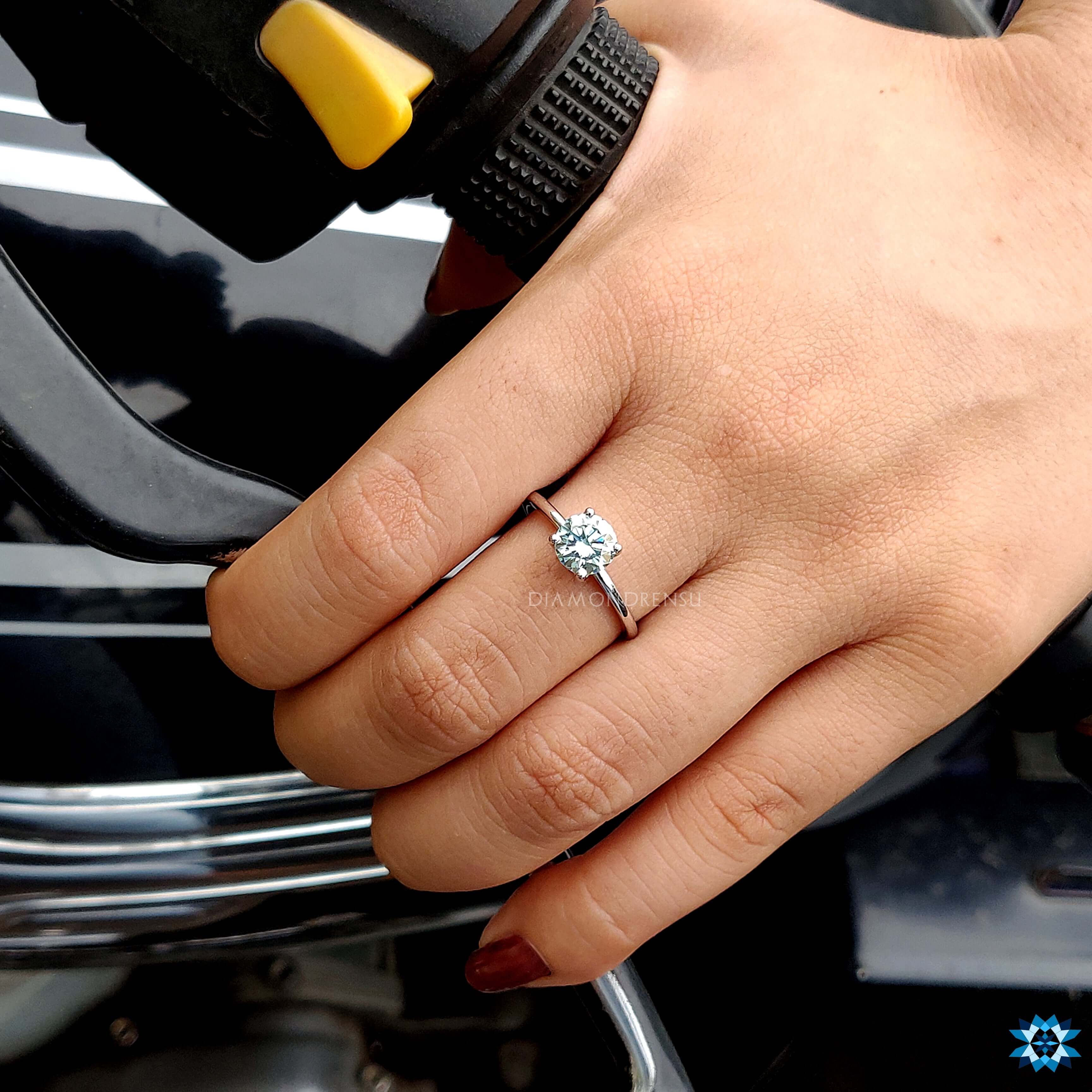 Handmade jewelry featuring a round brilliant cut engagement ring in white gold.