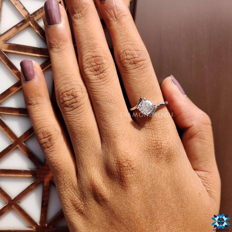 Contemporary cushion cut moissanite ring in white gold.
