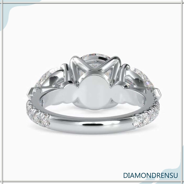 Elegant split band ring with pear and round diamonds.
