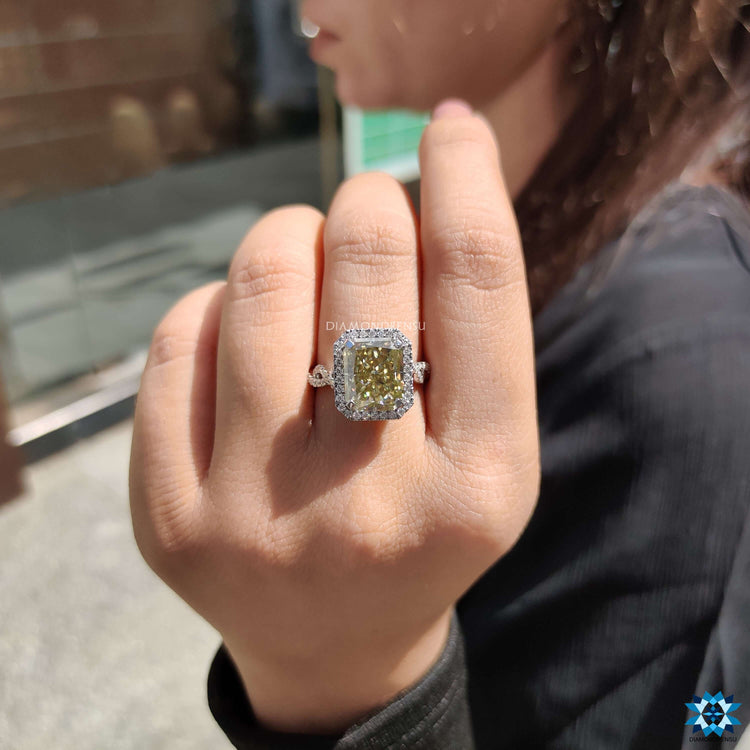White gold radiant engagement ring with twisted pave band.
