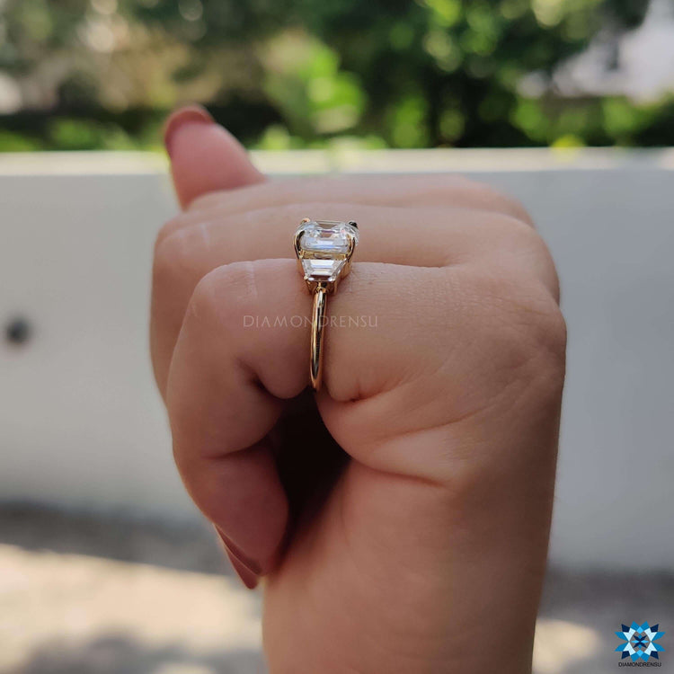 Yellow gold engagement ring with clean-lined asscher and trapezoid combo.
