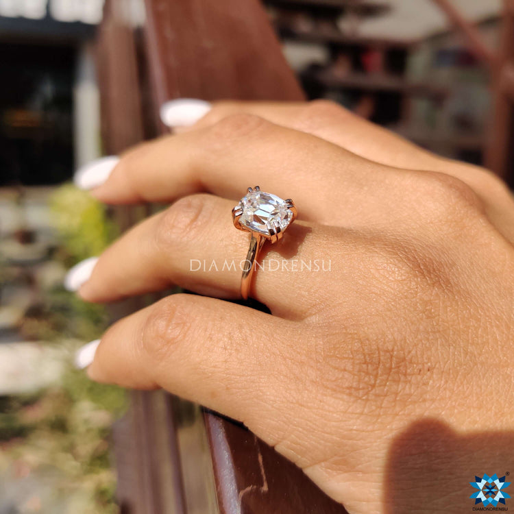 Rose gold solitaire ring with elongated cushion OEC moissanite.
