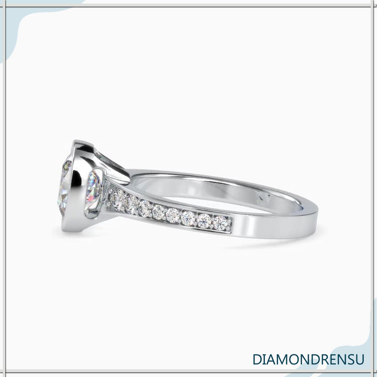 Yellow gold engagement ring with round cut pave detail.
