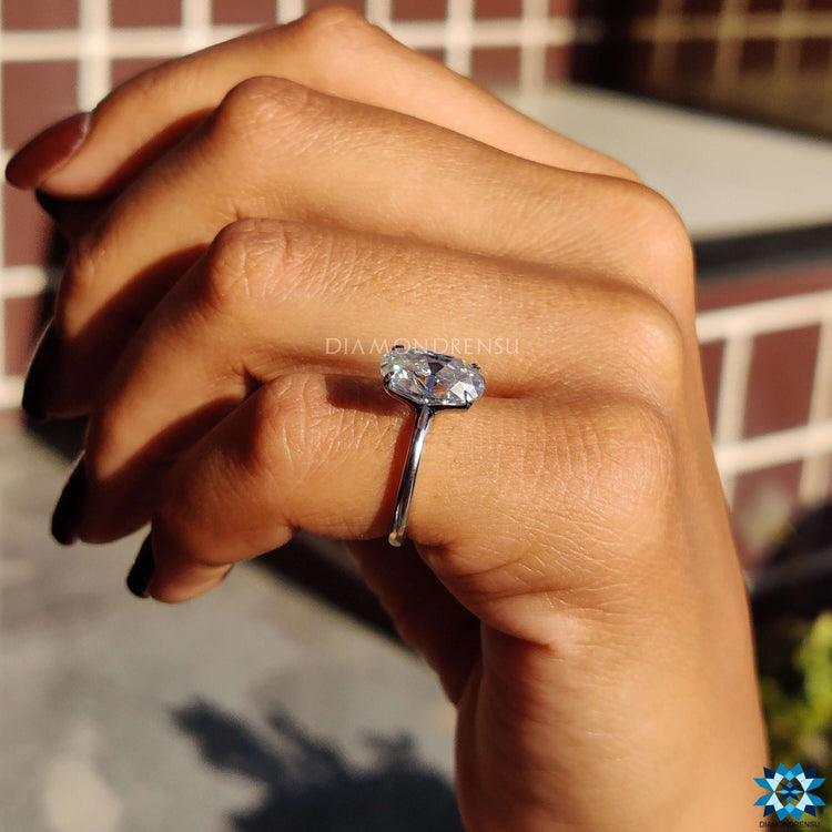White gold ring with four prong Moval cut moissanite.
