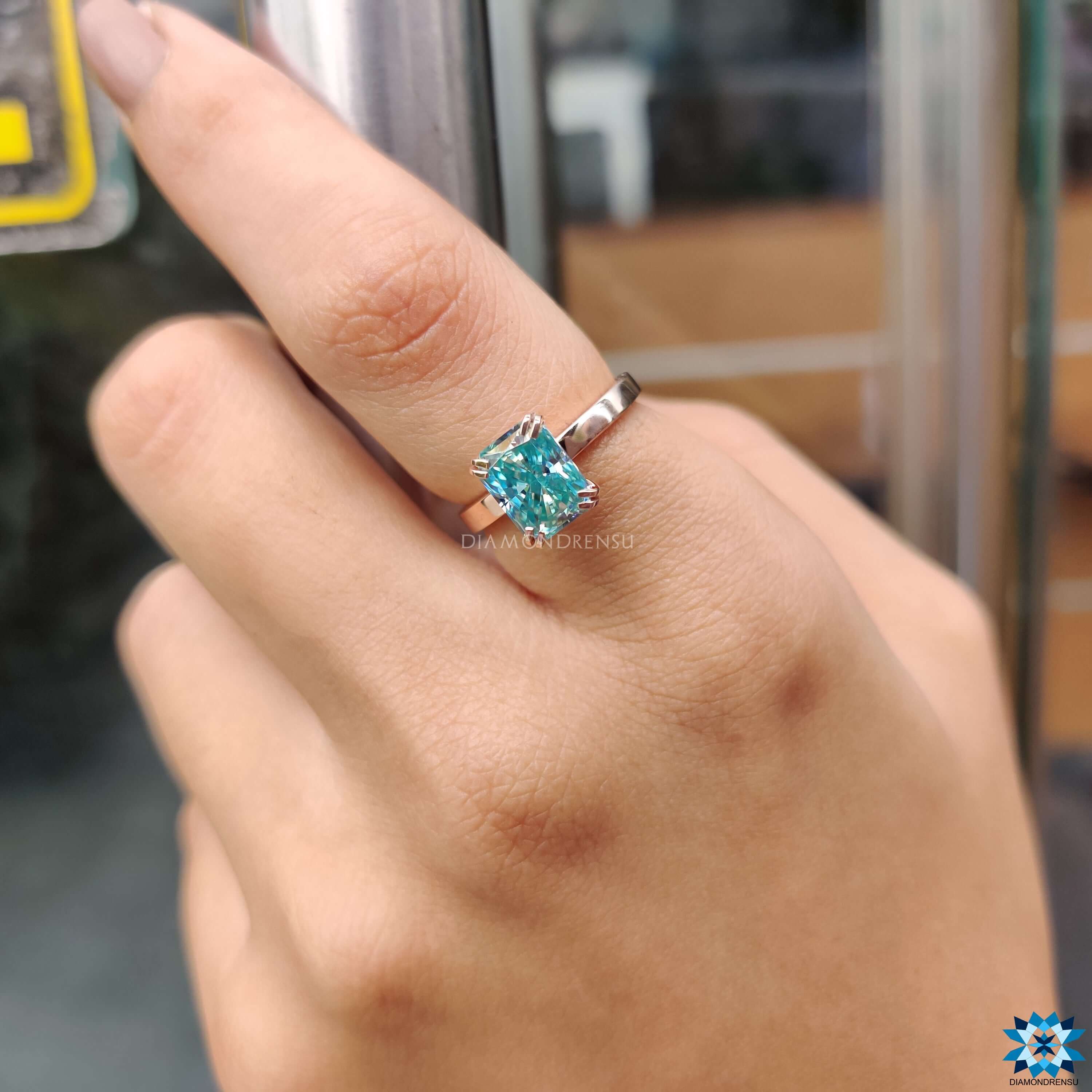 Handmade ring with a blue moissanite ring and radiant cut moissanite ring for extra brilliance.