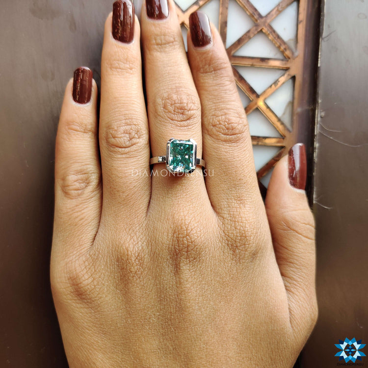 Half bezel setting engagement ring with radiant cut moissanite.
