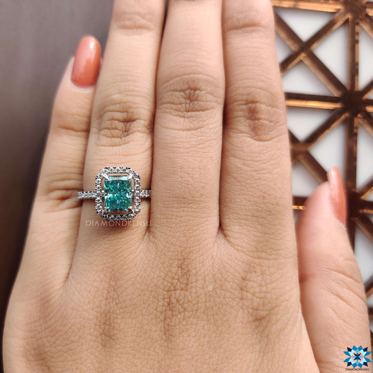 Elegant engagement ring with radiant blue moissanite center.
