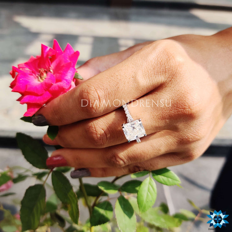 Pave setting ring featuring a radiant cut centre stone and round cut band.
