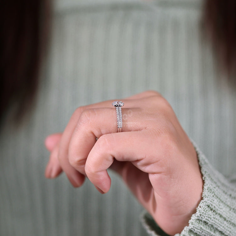 Double row pave engagement ring with a round diamond centrepiece.
