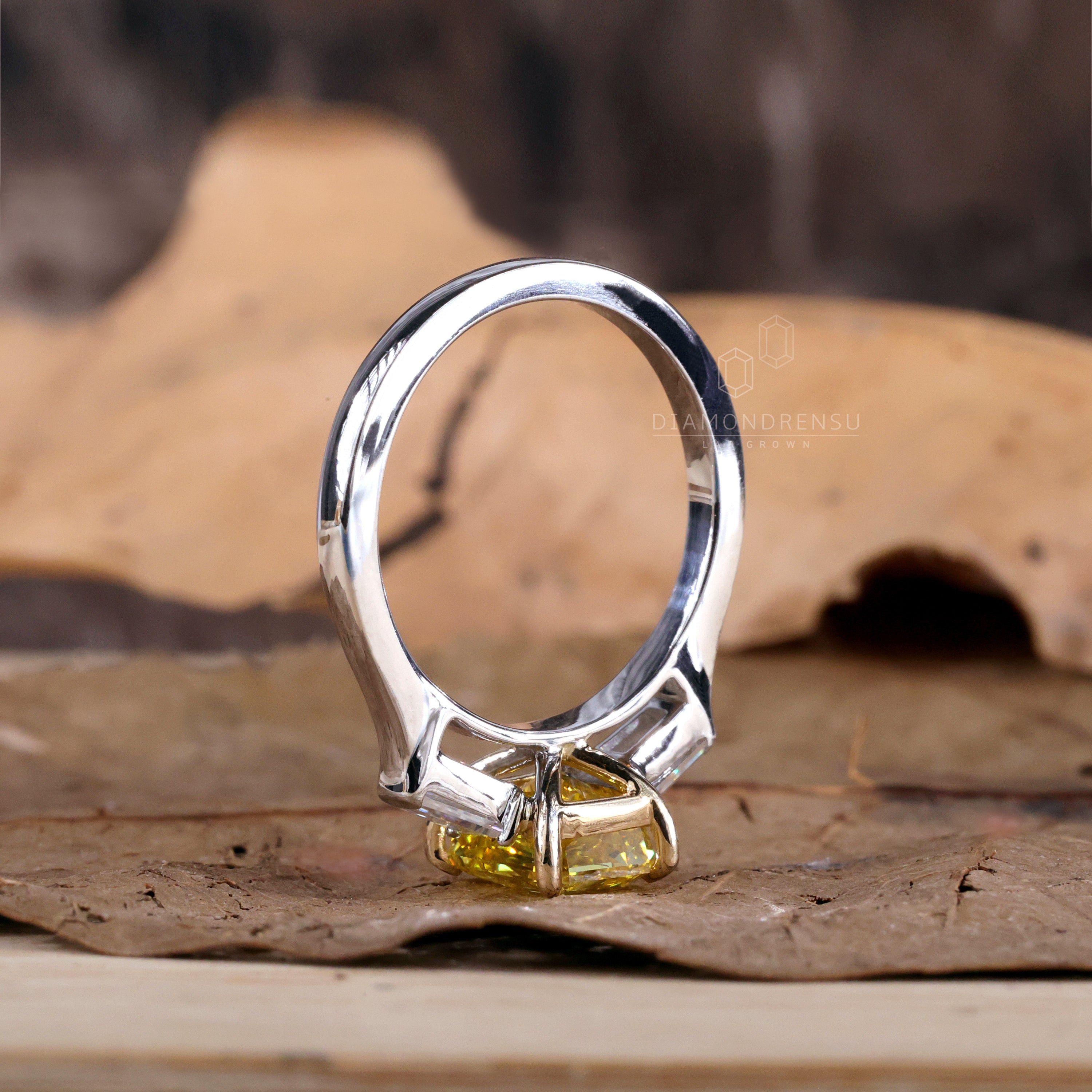 Baguette diamond ring featuring a lab grown diamond with a vivid yellow centre.